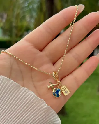A charm chain held in the palm of a hand.