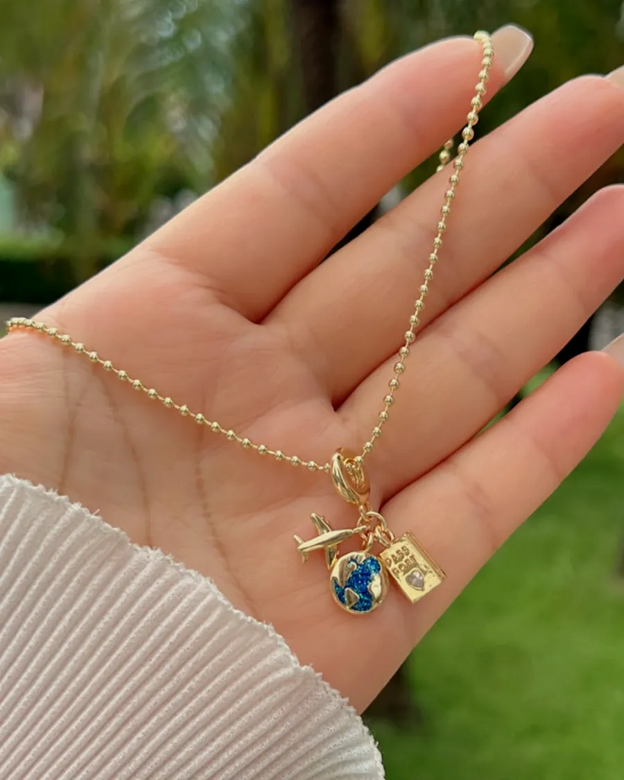 A charm chain held in the palm of a hand.