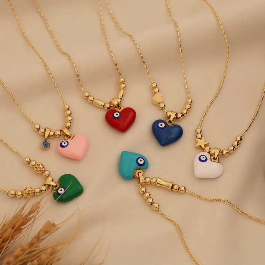 Six gold-tone chain necklaces with an enamelled heart pendant in pink, red, blue, turquoise, green and white.