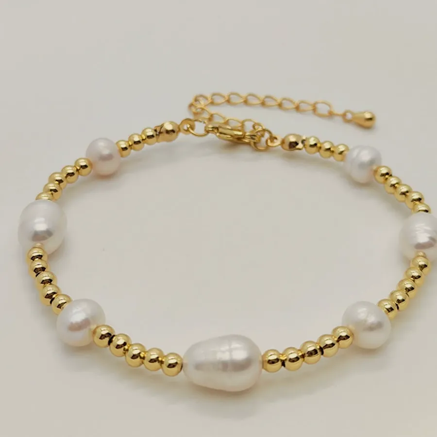 Bracelet of freshwater pearls alternating with gold-tone beads and an extender clasp.